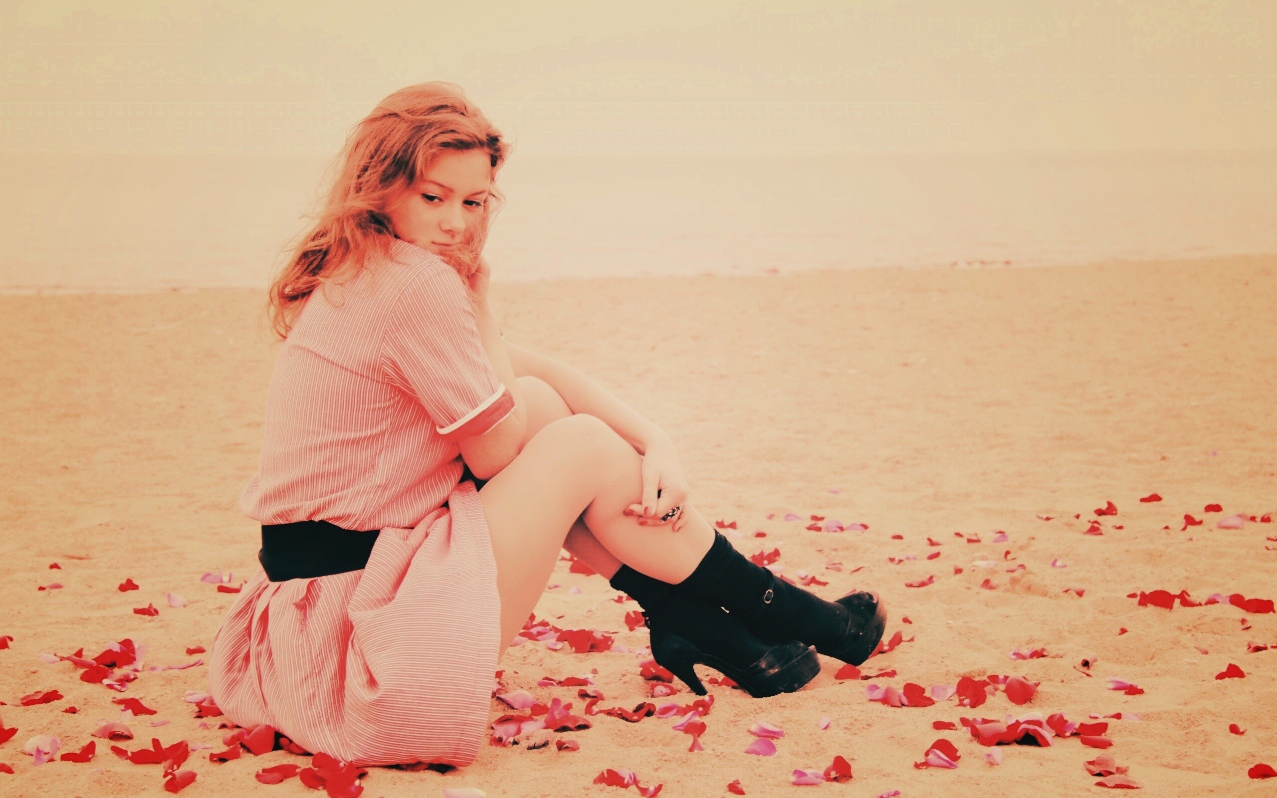 Девушка среди лепестков на пляже обои