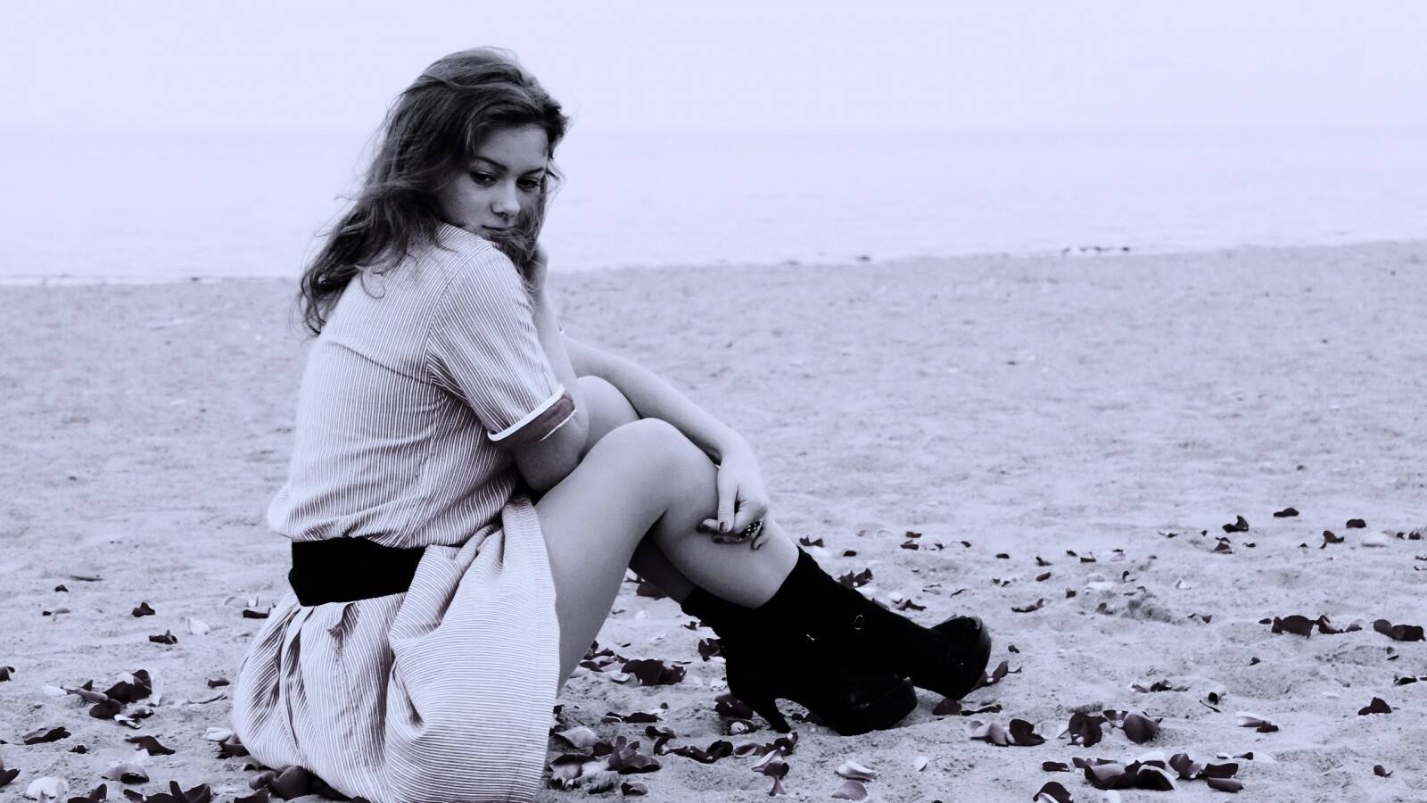 Девушка среди лепестков на пляже обои