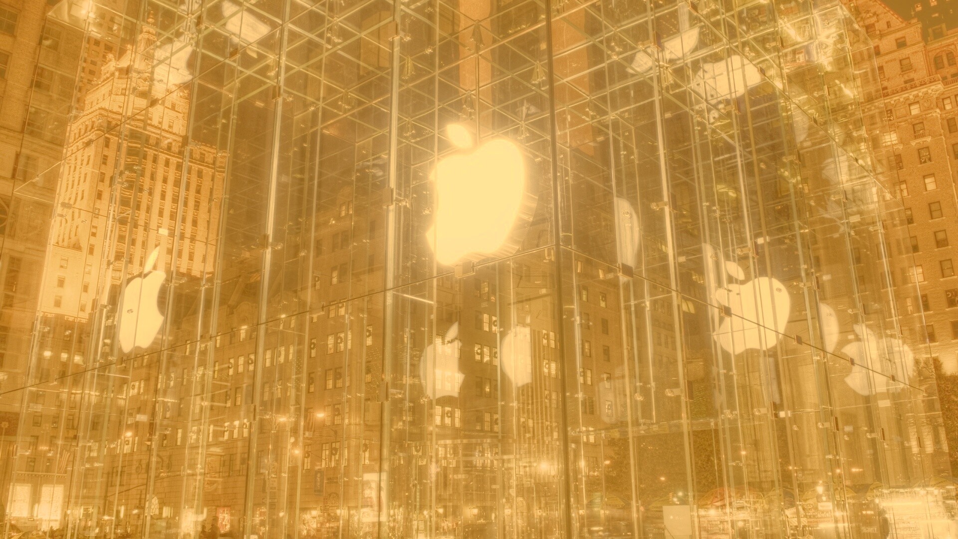 Отражение логотипа Apple в стеклянном здании обои