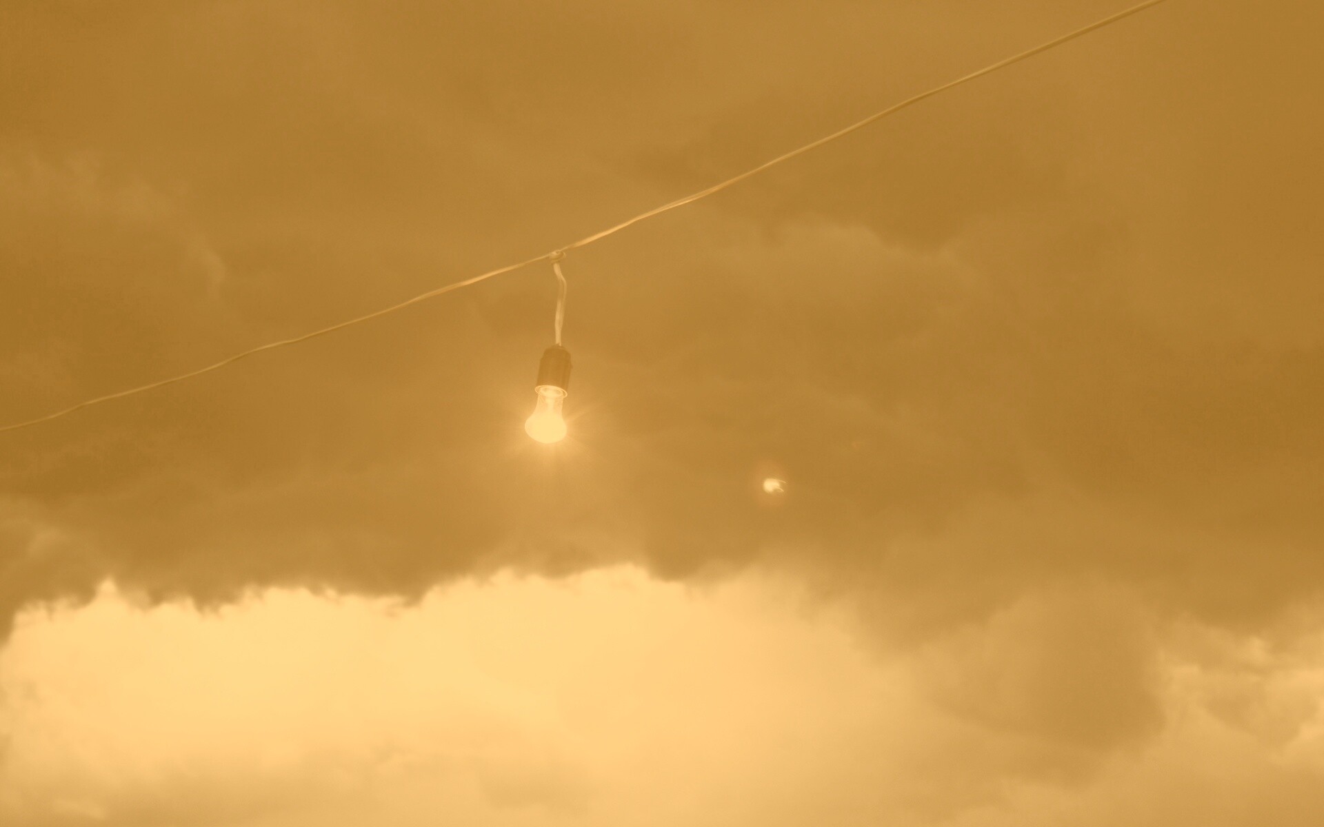 Лампочка на фоне туч обои