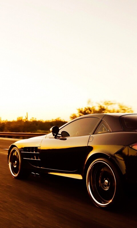 Черный автомобиль уезжает в закат обои