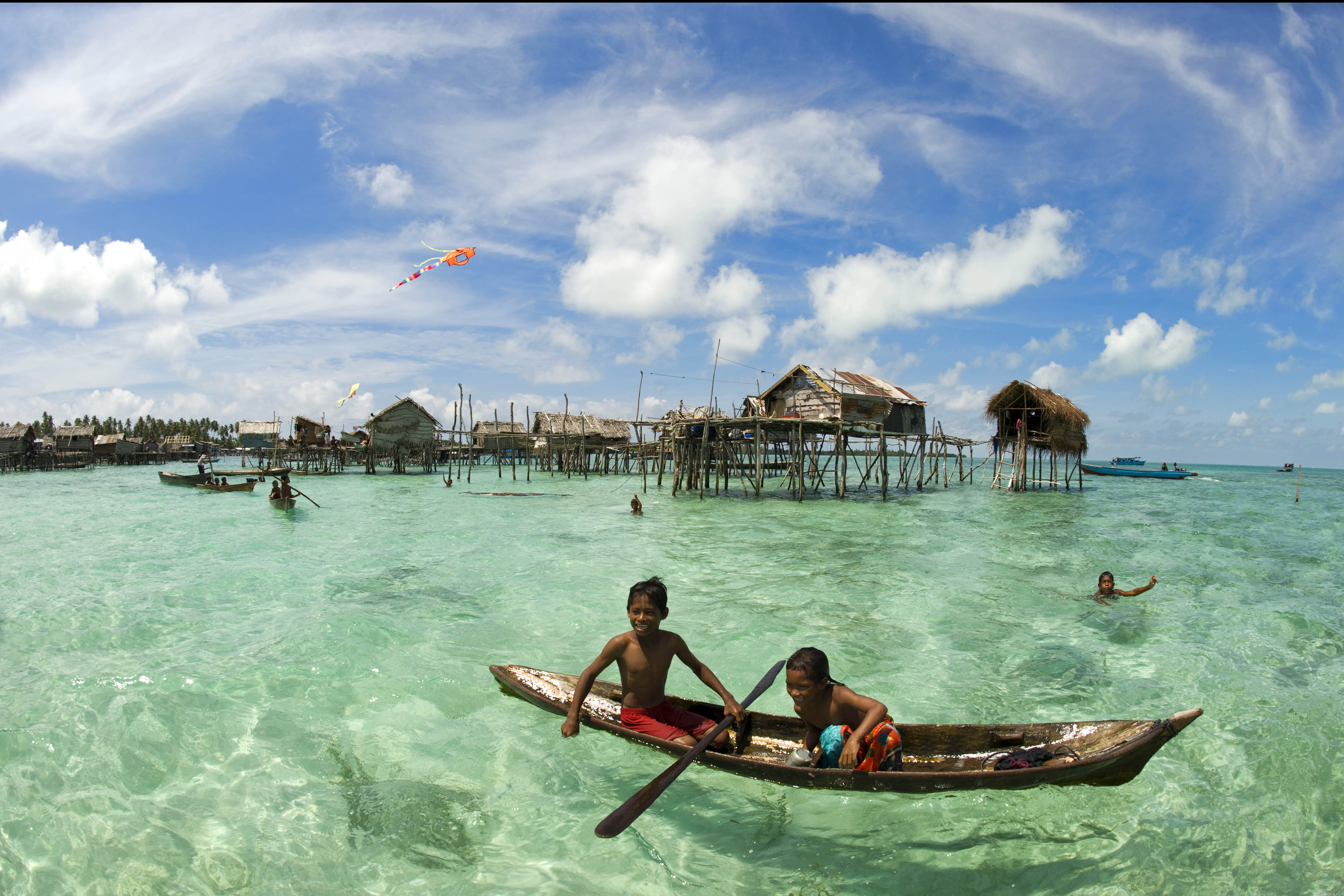 Дети в лодке у поселения туземцев обои